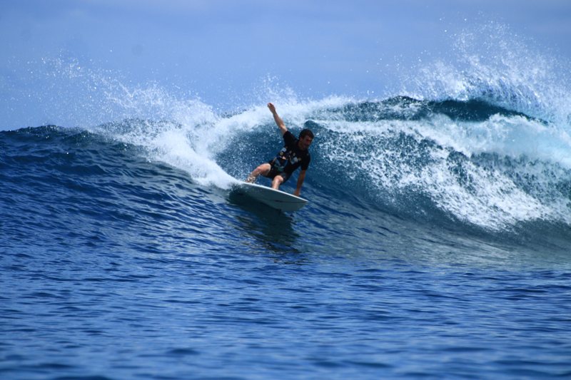 Gunturs: A surfer riding a wave in the Banyak Islands
