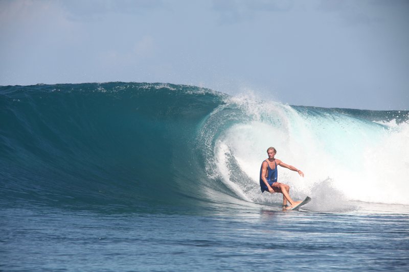A surfer turning across the open face at Gunturs