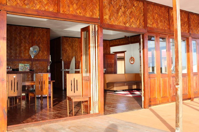 Open wooden villa doors leading from the private patio into the room
