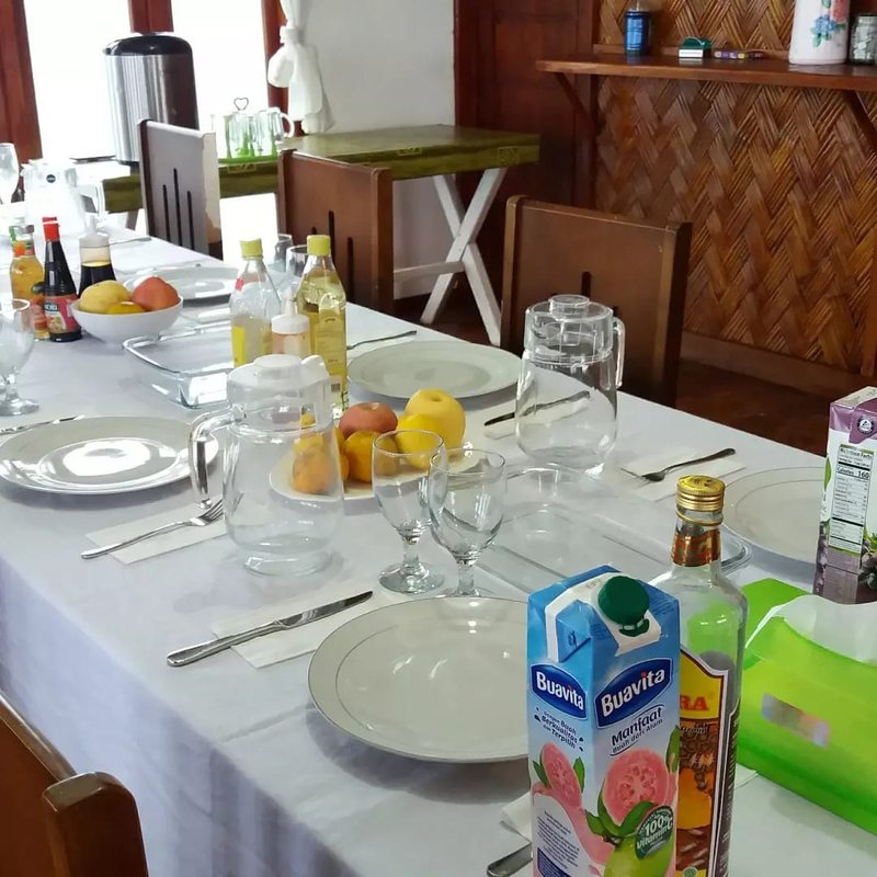 The dining table set with juices and fruit