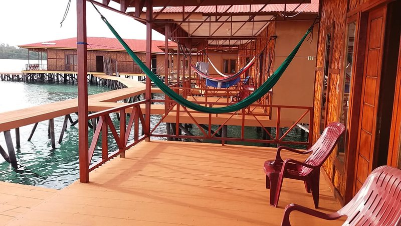 A hammock on a covered wooden villa patio
