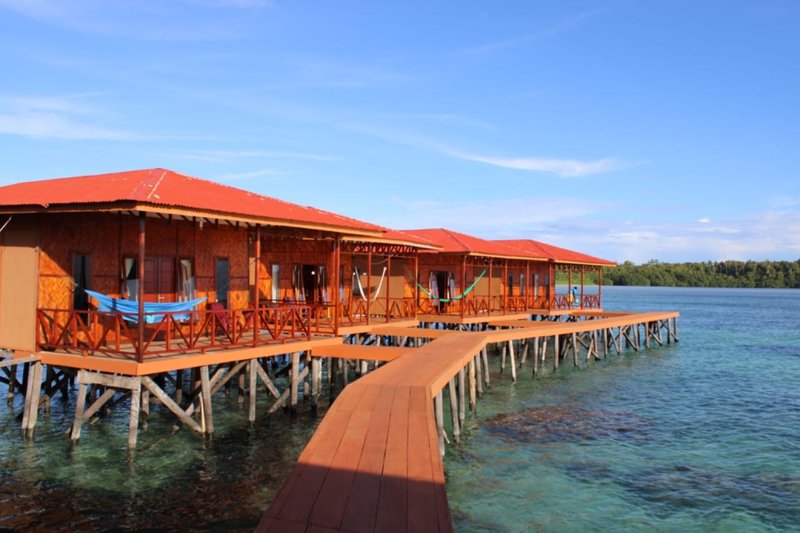 The overwater villas and boardwalk above the reef
