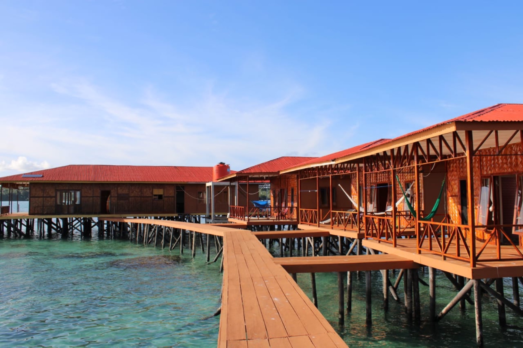 The overwater villas and boardwalk seen from the water